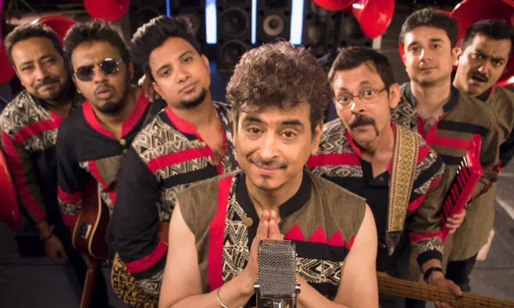Euphoria with Palash Sen in the foreground, are posing for a lively band photo with musical instruments in the background.