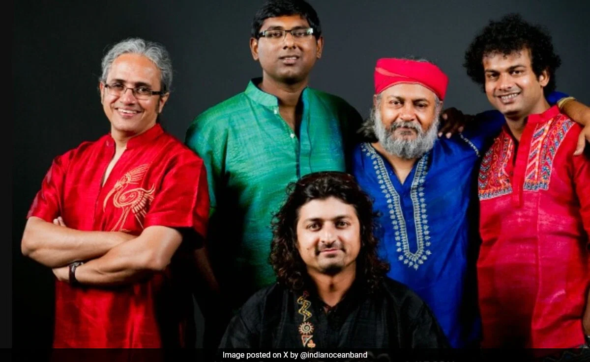 Indian Ocean band, are posing for a studio portrait, with some wearing traditional Indian attire.