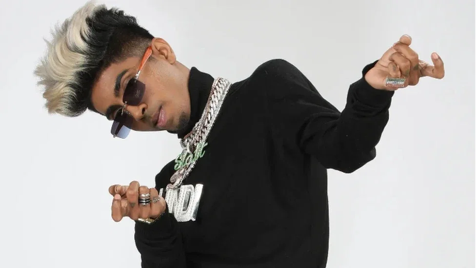 MC stan posing for picture with a white background