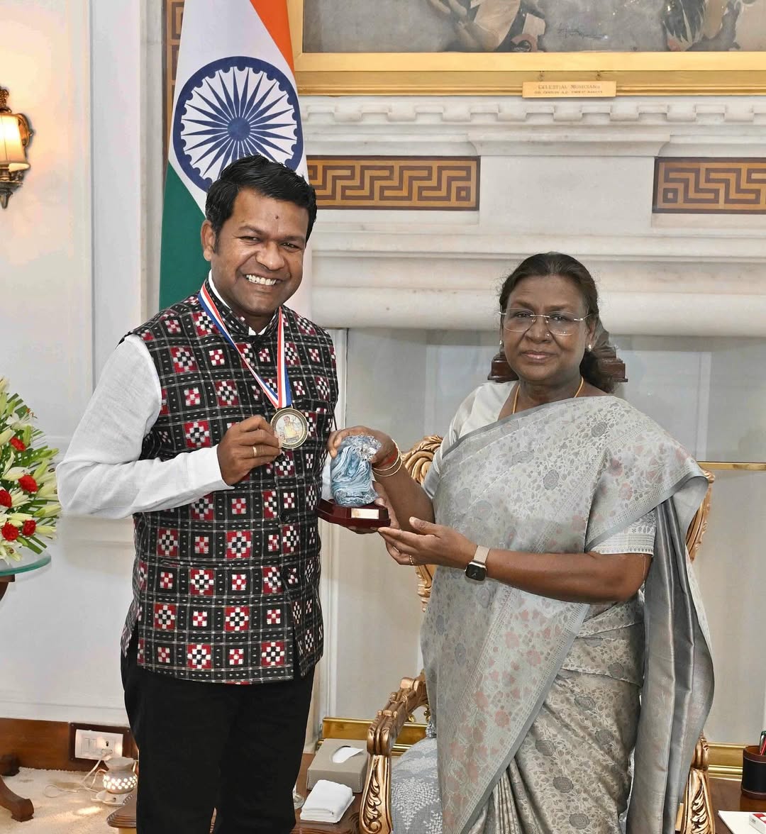 Sudarshan Patnaik posing with his medal. He is a variety artist.